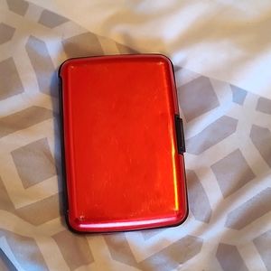 Red metal case for cards.